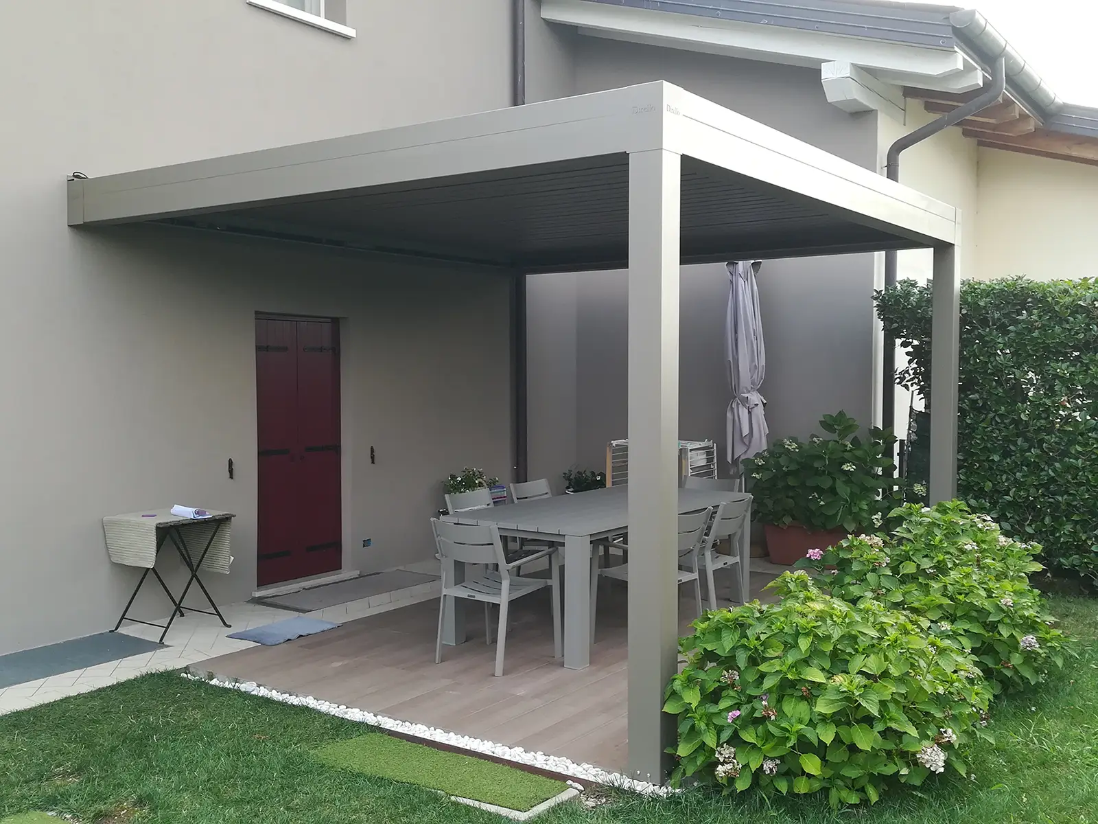 Tecnozen foto di pergola bioclimatica orientabile 4.0 addossata su spazio esterno di una casa privata